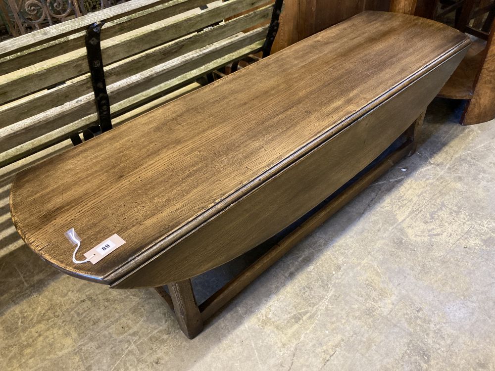 A reproduction oak drop flap coffee table, width 150cm, depth 45cm, height 43cm